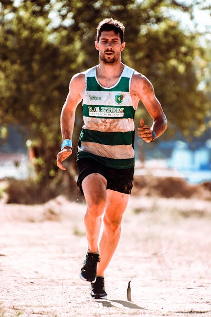 Home A determined male runner competes in an outdoor race, showcasing endurance and athleticism.