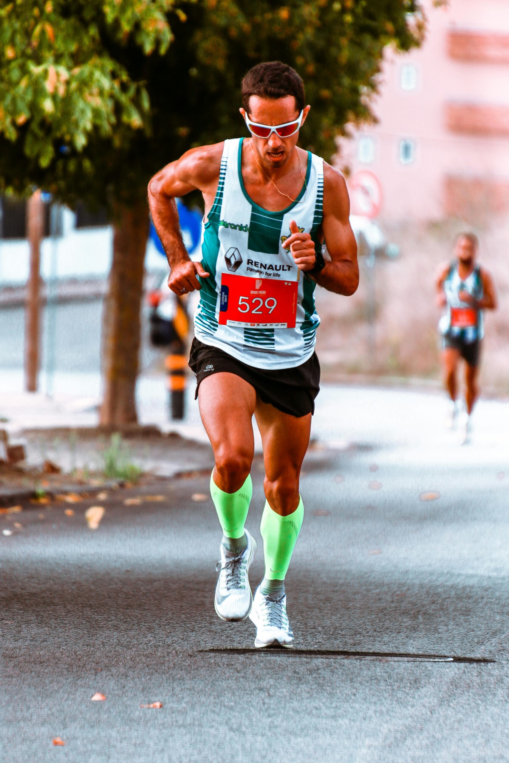 Home Male athlete competing in a street marathon, showcasing endurance and determination.